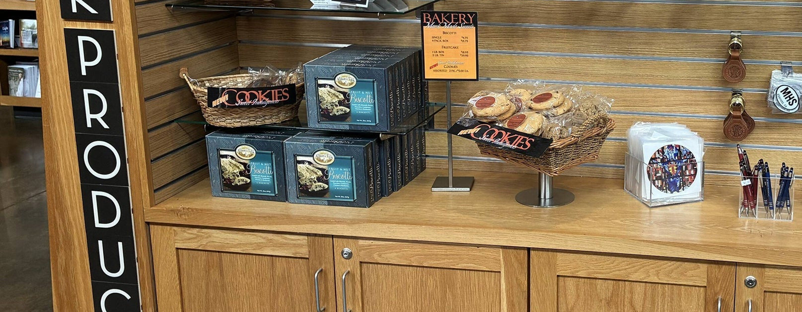 Baskets of monk-made cookies and stacked boxes of Fruit and Nut Biscotti on the bakery shelf in the Abbey Store.