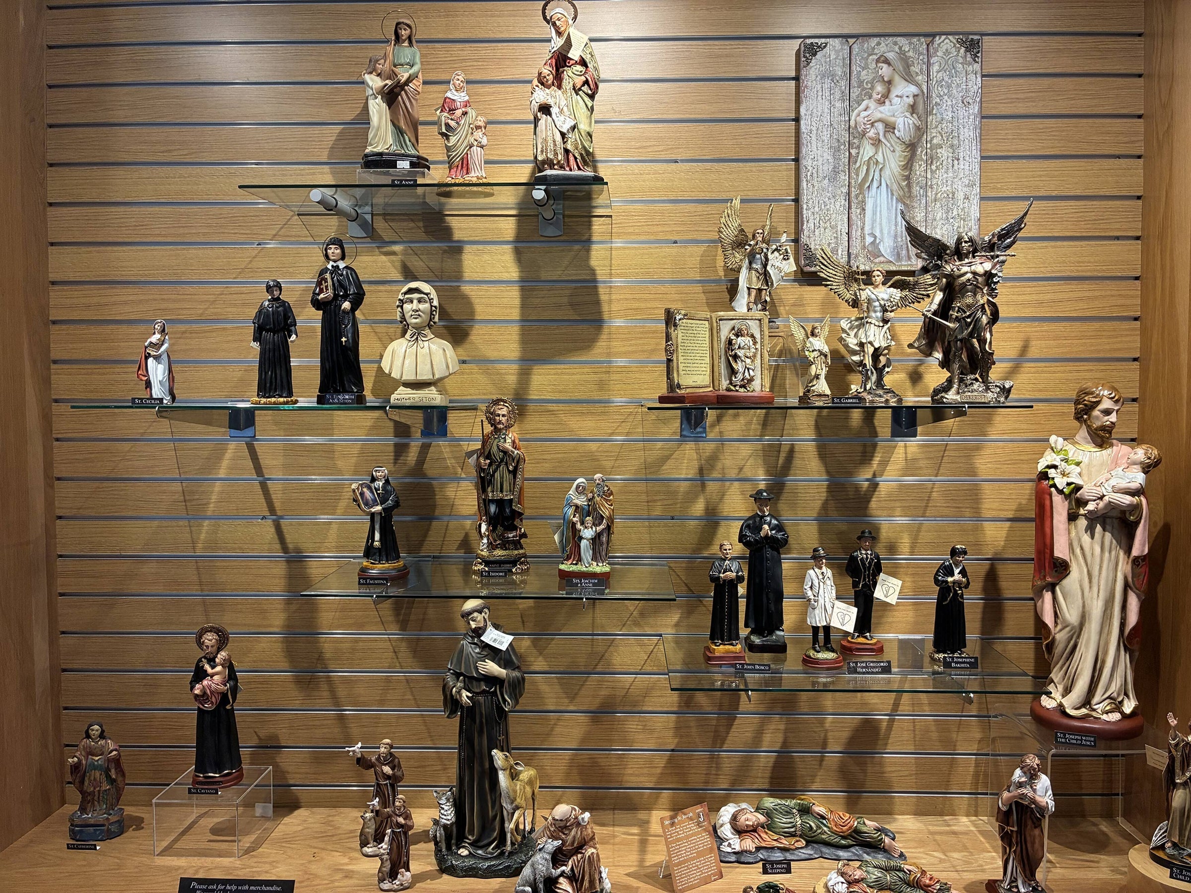 Shelves of carved and painted saint statues in the Abbey Store.